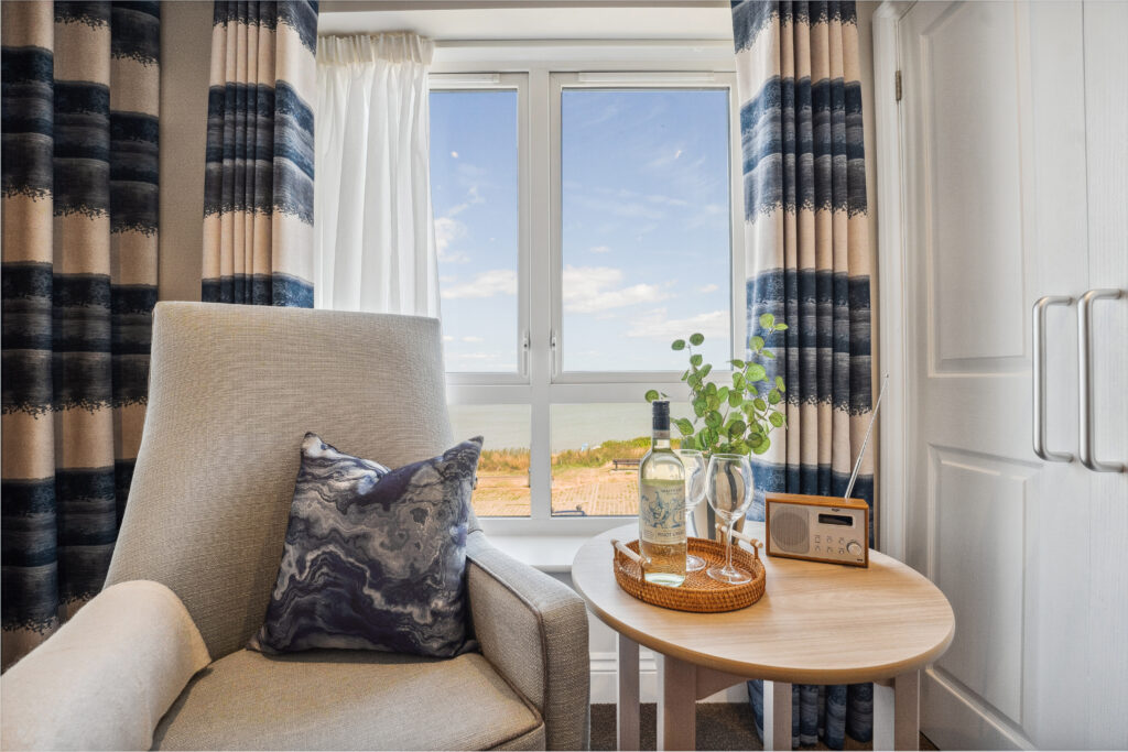 Ocean Heights Care Home arm chair and table with seaside view